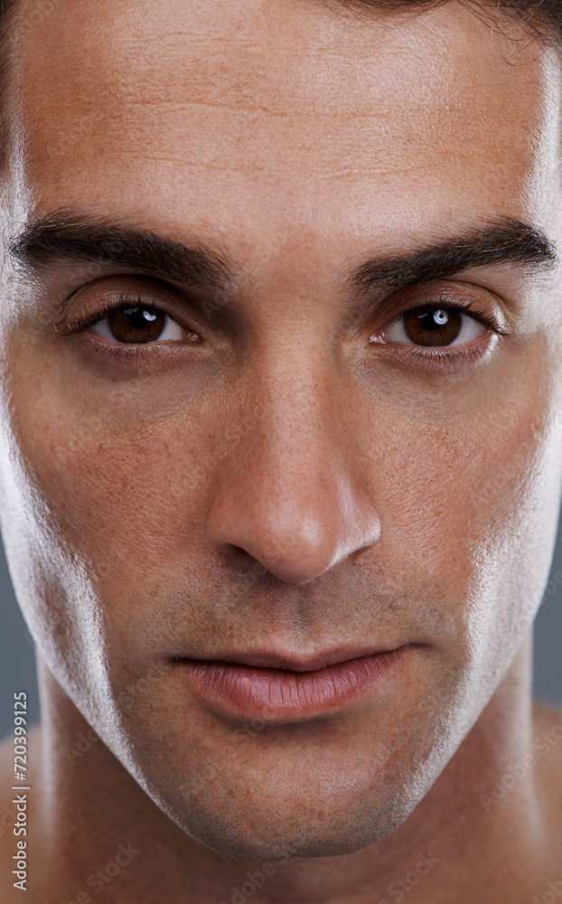 Fototapeta premium Portrait, skincare and man with cosmetics, closeup and dermatology on grey studio background. Face, person or model with beauty or grooming with routine or wellness with glow, aesthetic and self care