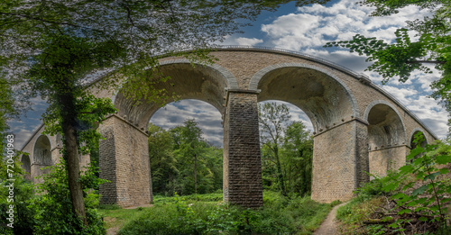 Dardilly, France - 08 05 2023: View of a railway bridge from the bottom of the forest. photo