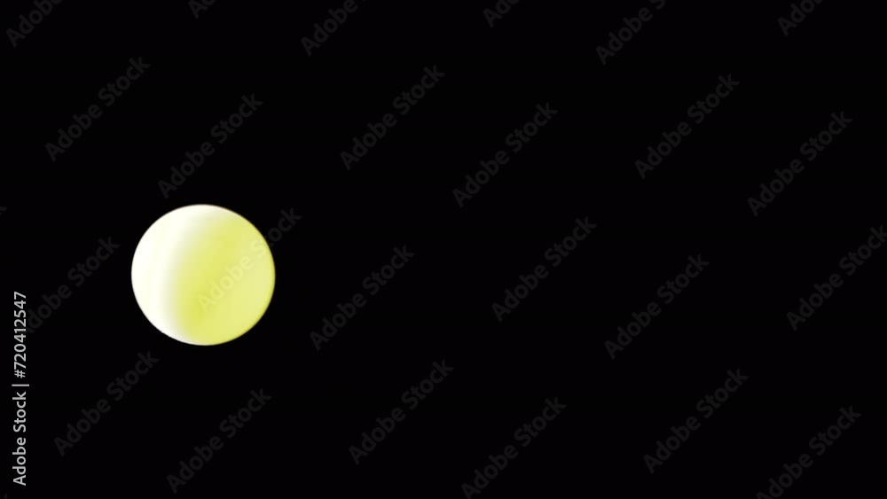 Rotating Yellow Ball or Sphere Flies in Blank Space on a Black Background. Abstract. Plastic ball moves slowly across the screen, and balances in air flow. Levitation. Selective focus. Side lighting. Rotating Yellow Ball or Sphere Flies in Blank Space on a Black Background. Abstract. Plastic ball moves slowly across the screen, and balances in air flow. Levitation. Selective focus. Side lighting.