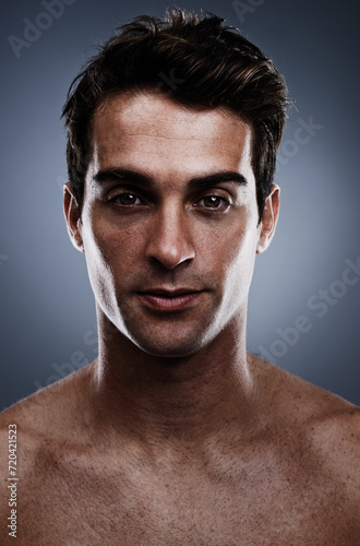 Portrait, skincare and man with cosmetics, wellness and grooming on grey studio background. Person, guy and model with routine or treatment with luxury and shine with beauty, glowing or dermatology
