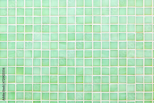 Light green bathroom mosaic tiles with white joints.