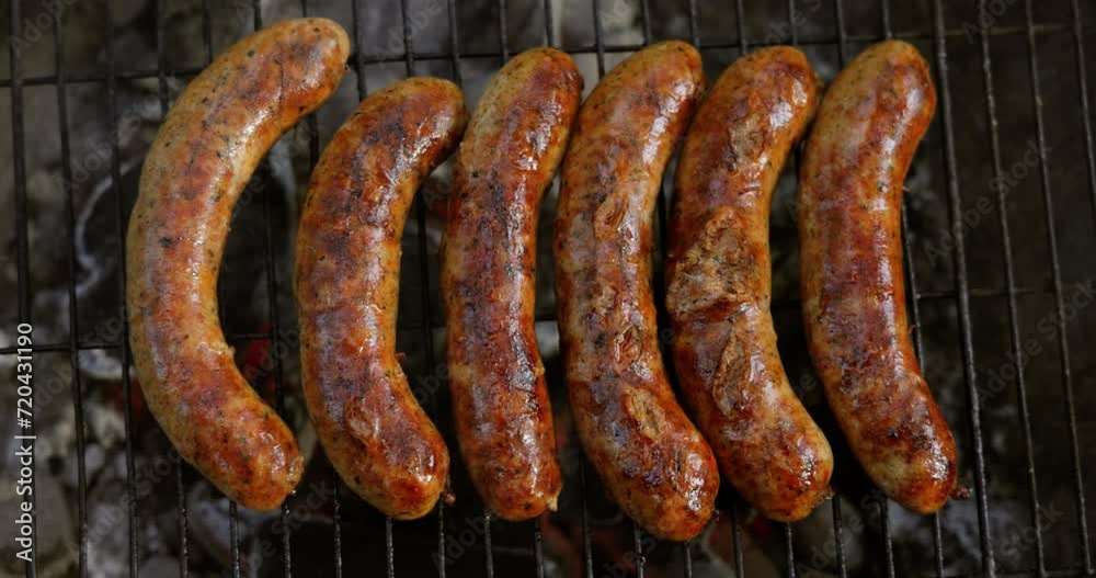 Delicious juicy sausages, cooked on the grill with a fire. Delicious juicy sausages, cooked on the grill with a fire.