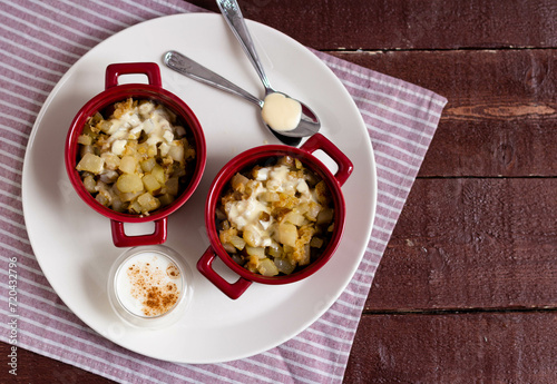 Baked vegetables with white sauce in pots. View from the top
