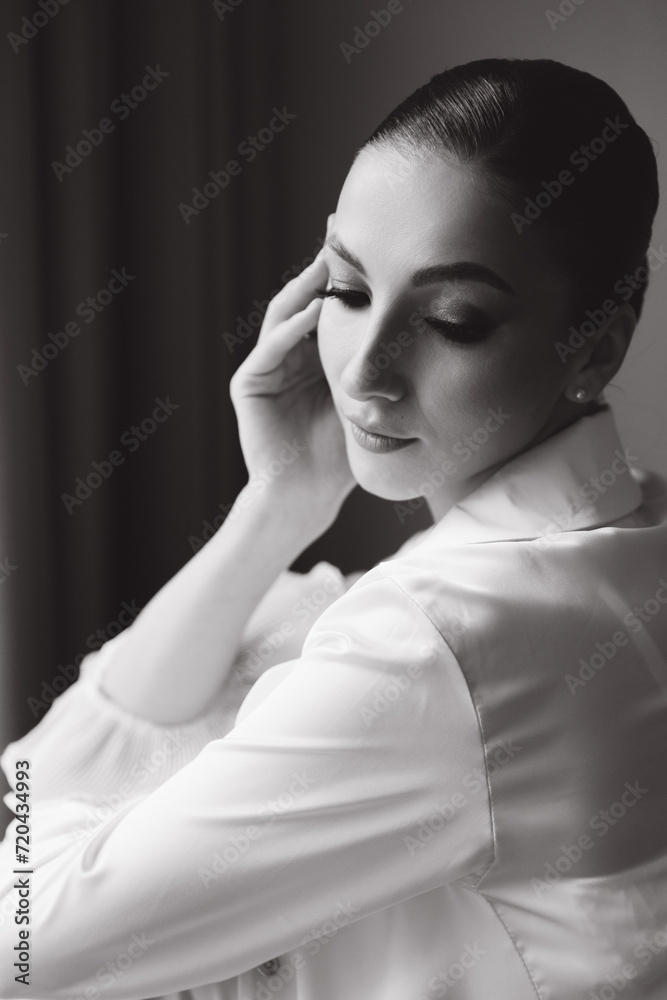 Morning and getting ready for a luxurious and beautiful bride in a hotel in a luxury room in pajamas and lingerie, putting on shoes and a chic white wedding dress Morning and getting ready for a luxurious and beautiful bride in a hotel in a luxury room in pajamas and lingerie, putting on shoes and a chic white wedding dress