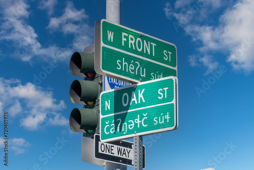 Low angle view of bilingual (English and Klallam) street signs on the Port Angeles, WA, USA waterfront as a way to honor the Lower Elwha Klallam Tribe, whose traditional land this is photo
