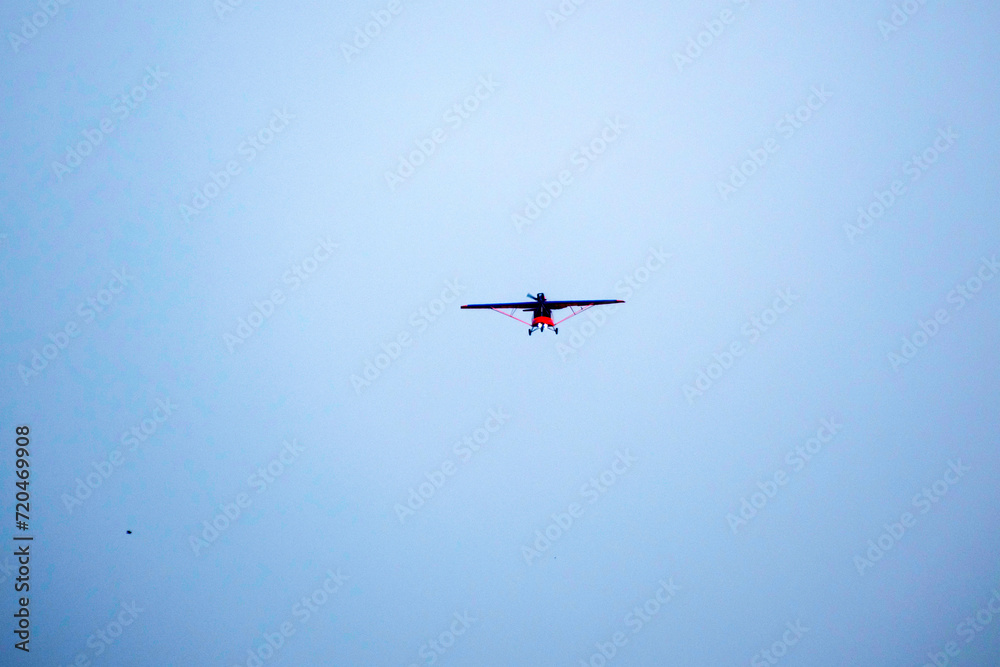 Old propeller plane is flying on isolated blue sky Old propeller plane is flying on isolated blue sky