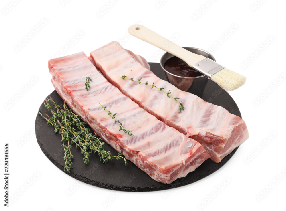 Raw pork ribs, thyme and sauce isolated on white Raw pork ribs, thyme and sauce isolated on white