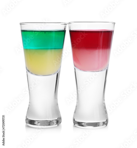 Different shooters in shot glasses isolated on white. Alcohol drink