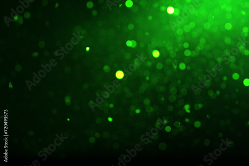 St. Patrick day. Black background with blurred green lights, bokeh effect