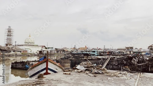 the wreck of a ship that had been burned by fire at the port dock of Tegal City photo