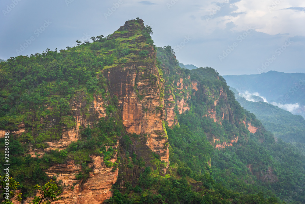 Panoramic view of Pachmarhi valley having clouds and mist shrouded hills rolling on each other from vantage point Priyadarshini Point in Pachmarchi, Madhya Pradesh, India.