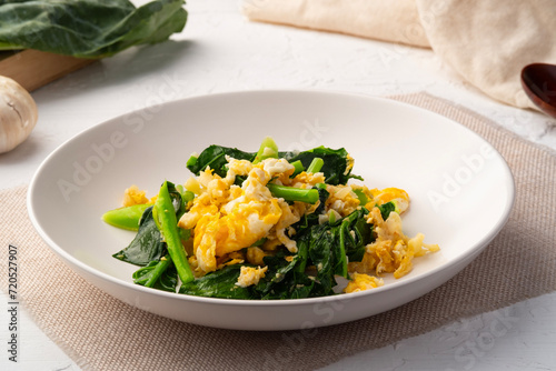 Stir fried Chinese kale with Eggs in white plate.Healthy and easy food.