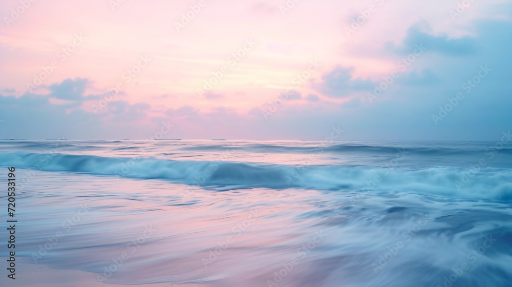 A calm beach yoga session at dusk soft pastel colors in the sky and gentle waves.