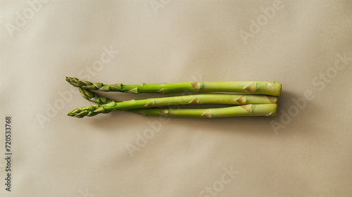 Asparagus on beige paper background. Healthy food aesthetic. Vegan food. Spring season vegetable. 