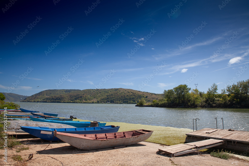Panorama of the danube river and the beginning of the iron gats with wooden fishing boats in Banatska Palanka, Serbia, in summer. Panorama of the danube river and the beginning of the iron gats with wooden fishing boats in Banatska Palanka, Serbia, in summer.