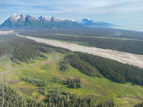 Middle Glacier creek in Lake Clark National Park and Preserve in Alaska. River originates from glaciers and drain into Cook Inlet. Braided river rich with sediment. Chigmit Mountains. photo