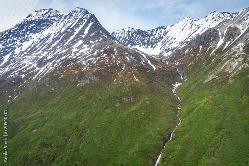 Steep waterfall flowing over cliff in Lake Clark National Park and Preserve, Alaska.  photo