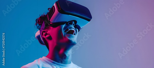 Young man using virtual reality headset Isolated on blue neon background studio portrait