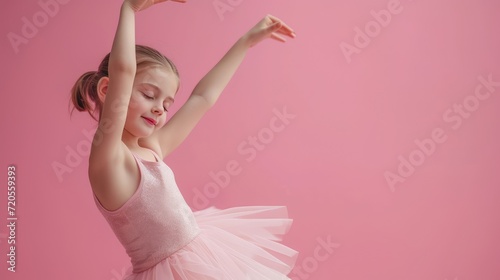 A poised young girl in a ballet outfit gracefully practicing her dance moves. photo