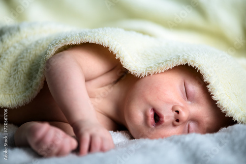 The quiet beauty of a sleeping newborn baby boy, swaddled in the tender embrace of a soft and plush blanket