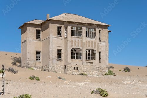 forsaken former "Quartermeister" building on sand at mining ghost town in desert, Kolmanskop, Namibia