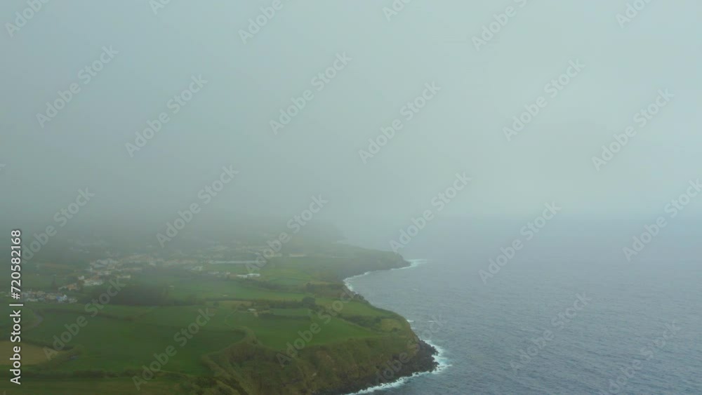 Aerial shot, drone point of view rocky coastline, Atlantic Ocean coastline of Island of Sao Miguel, Azores, Portugal. Travel destinations and beauty in nature concept