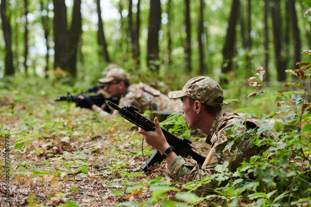 Elite soldiers stealthily maneuver through the dense forest, camouflaged in specialized gear, as they embark on a covert and strategic military mission