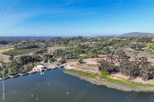 Fototapeta Naklejka Na Ścianę i Meble -  Aerial view over water reservoir and a large dam that holds water. Rancho Santa Fe in San Diego, California, USA
