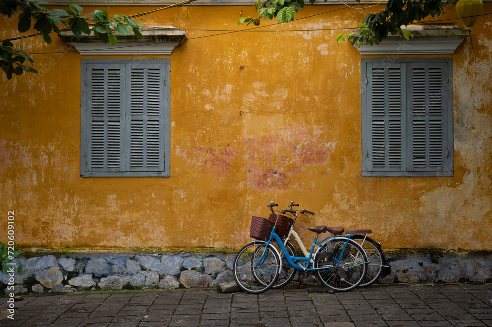 The yellow stuccoed buildings of Hoi, An, the Unesco Wold Heritage Site with two bicycles The yellow stuccoed buildings of Hoi, An, the Unesco Wold Heritage Site with two bicycles