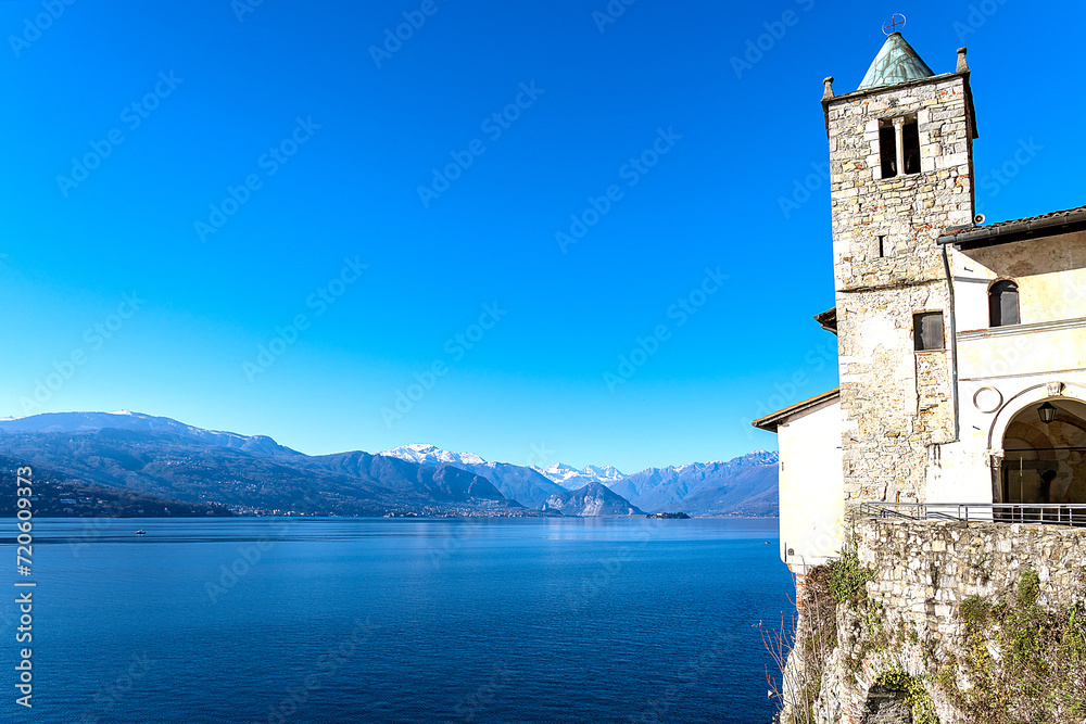 Panoramic view of Lake Maggiore with Isola Bella and Isola dei Pescatori, and on the right a view of the twelfth-century hermitage of Santa Caterina del Sasso with its bell tower