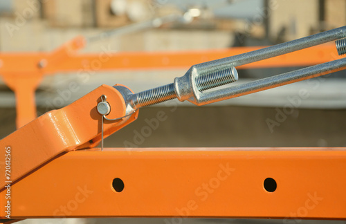 Rope lockers in rear beam of suspended wire rope platform for facade works on high multistorey buildings. Rope lockers blocks rope kink for safety platform usage photo