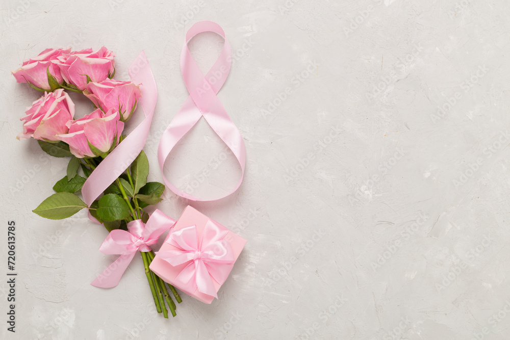 Composition with pink roses, gift box and eight made of ribbon on concrete background, top view. Women's day concept Composition with pink roses, gift box and eight made of ribbon on concrete background, top view. Women's day concept