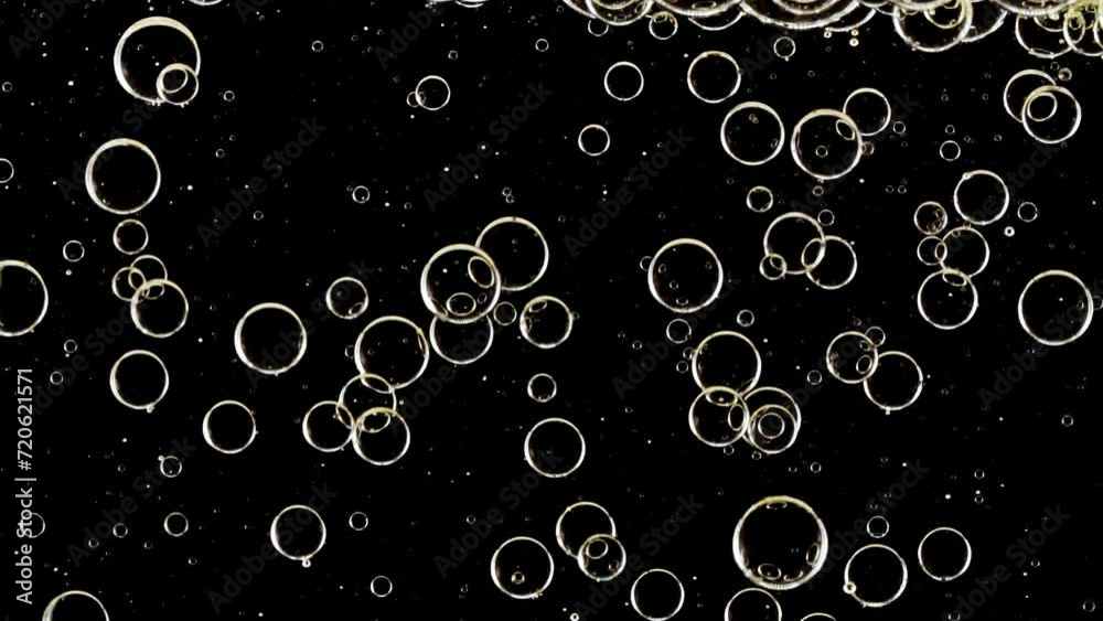 Macro Shot of Different Sized Clear Air Bubbles in Clear Water Rising up on Black Background. Body Care Cosmetics Concept. Essence, Liquid Bubble, Molecule. Slow Motion . High quality FullHD footage Macro Shot of Different Sized Clear Air Bubbles in Clear Water Rising up on Black Background. Body Care Cosmetics Concept. Essence, Liquid Bubble, Molecule. Slow Motion . High quality FullHD footage