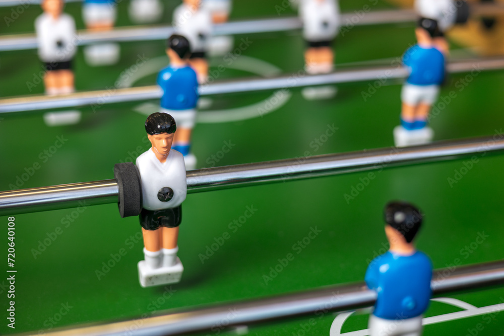 Fototapeta premium Close-up of blue and white football players playing table football