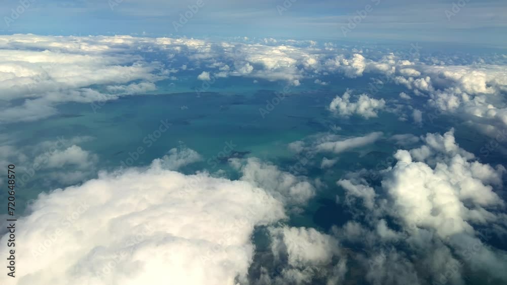VARADERO, CUBA - DECEMBER 20, 2023: View from the porthole on the Atlantic coast of Cuba. View of the turquoise ocean water and islands with snow-white sand from the plane. White clouds over the water VARADERO, CUBA - DECEMBER 20, 2023: View from the porthole on the Atlantic coast of Cuba. View of the turquoise ocean water and islands with snow-white sand from the plane. White clouds over the water