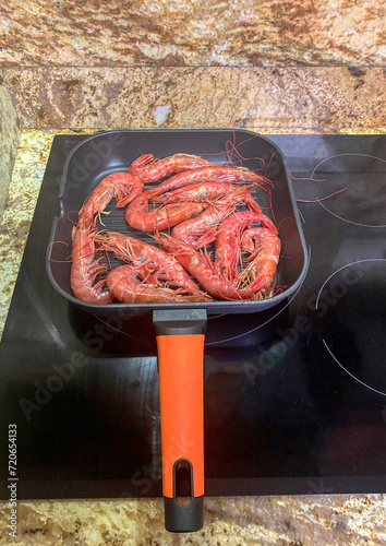 VIEW FRYING PRAWNS IN A GRILLED PAN photo