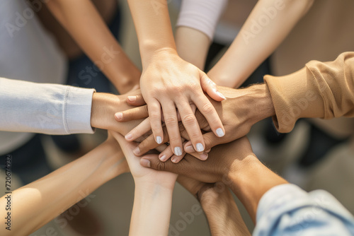 Team putting their hands on the center. Diverse group hands together. Team unity with cultural blend. People gathering in a symbolic center, showcasing teamwork, diversity, and cultural richness. © Pale