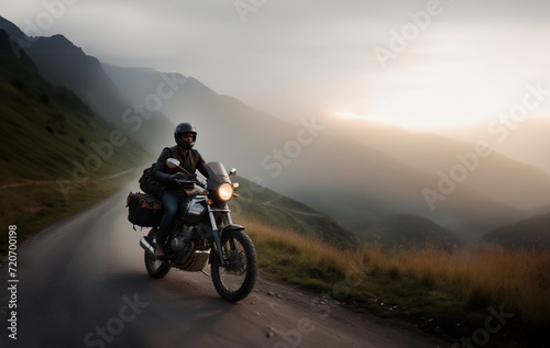 traveling on a tourist motorcycle with panniers in the mountains at dawn.