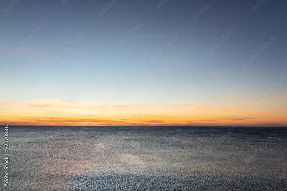 Sunrise on sea golden blue colors