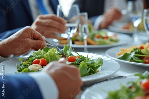 Diverse colleagues dinner meeting lunch in office restaurant businessmen group cafeteria cafe discussion business fine dining corporate teamwork expensive tasty dish food coworkers cheering talking
