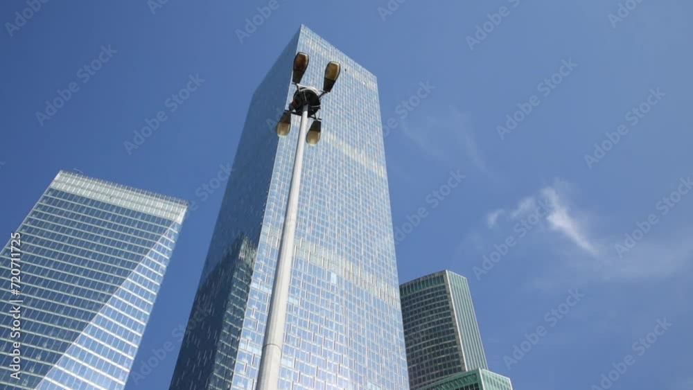 High modern buildings on a background of blue sky, view from below High modern buildings on a background of blue sky, view from below