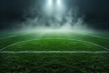 Misty soccer field with bright lights under a night sky.