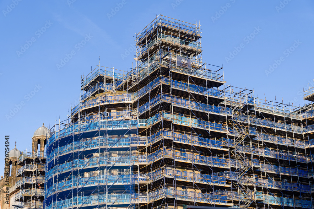 Scaffolding surrounding residential development for safe access to construction work
