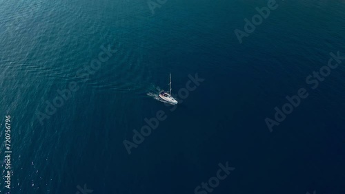 Aerial view of sailboat sailing on a deep blue sea. Yacht in blue ocean water, Yachting photo