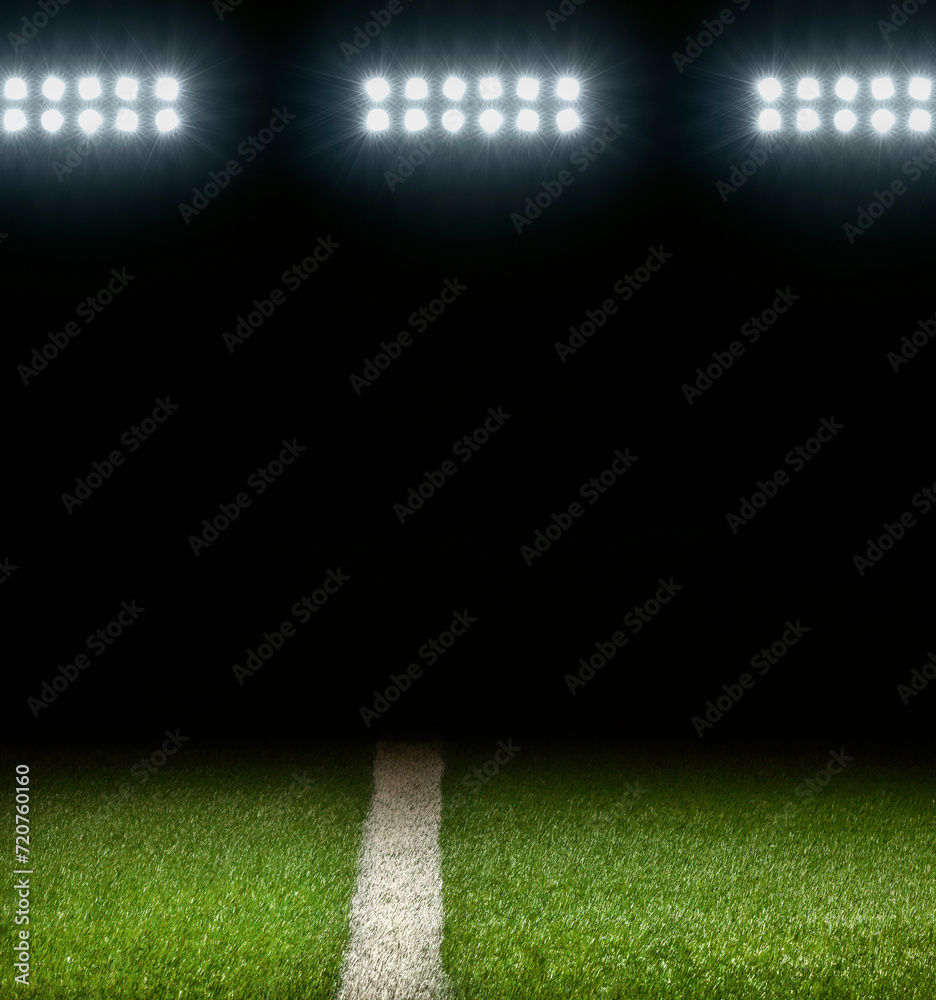 Grass athletic field with white stripe and dark background below stadium lights