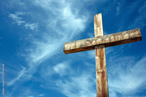 Wooden Christian cross against a blue sky