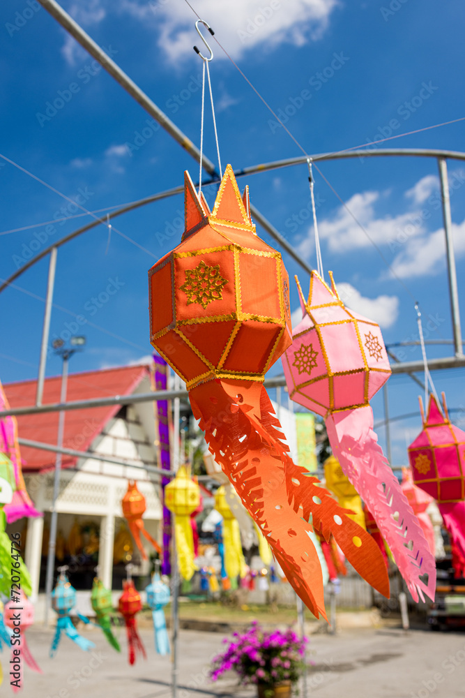 A group of vibrant lanterns suspended from a tall pole at Wat Chiang Man, creating a colorful and lively scene. A group of vibrant lanterns suspended from a tall pole at Wat Chiang Man, creating a colorful and lively scene.