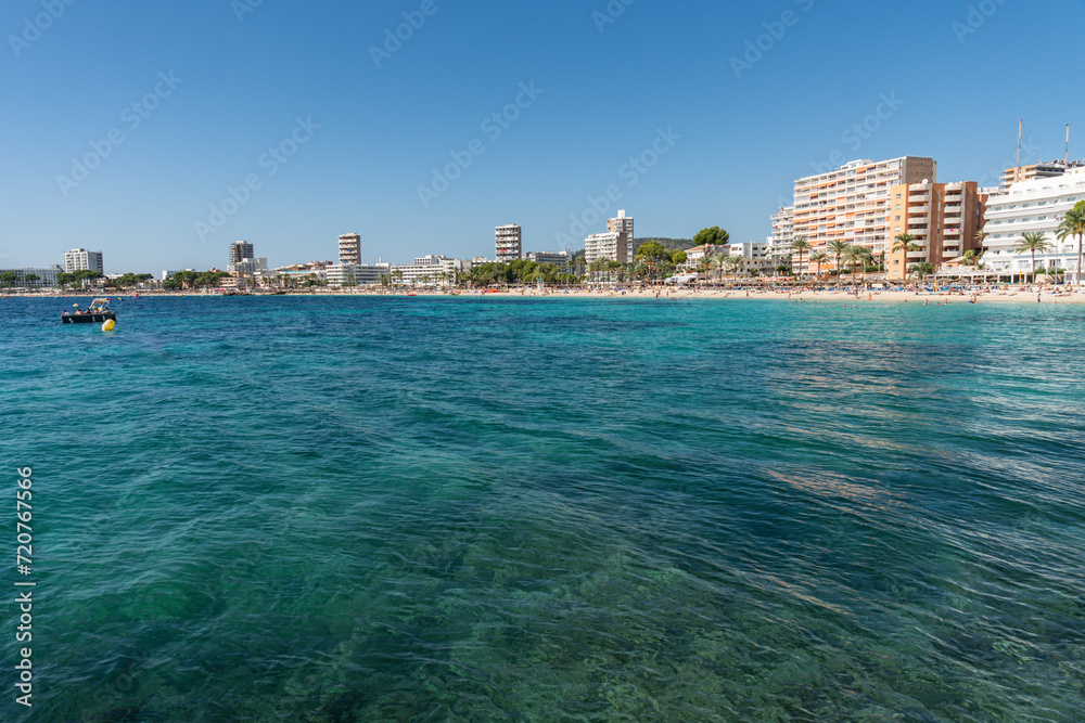 view of Magaluf bay and beach, with turquoise water in foreground view of Magaluf bay and beach, with turquoise water in foreground