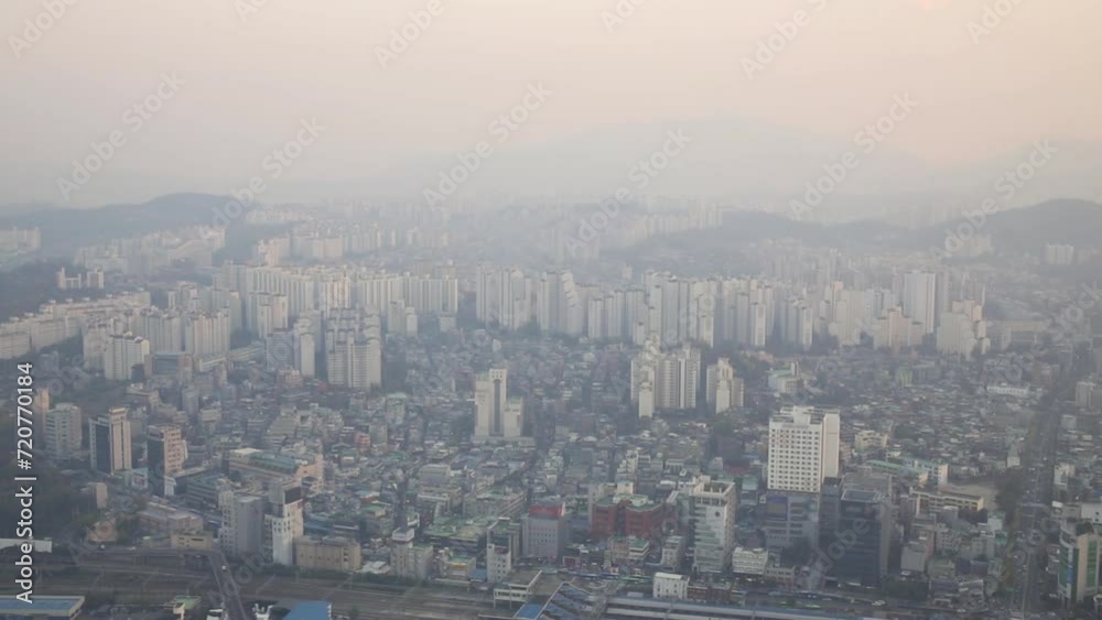 Rows of highrise apartment buildings, roads and mountains in smoke Rows of highrise apartment buildings, roads and mountains in smoke