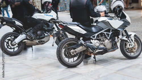 Hellenic Police, Greek police squad on duty riding bike and motorcycle, maintain public order in the streets of Athens, Attica, Greece, group of policemen with "Greek Police" logo emblem on uniform